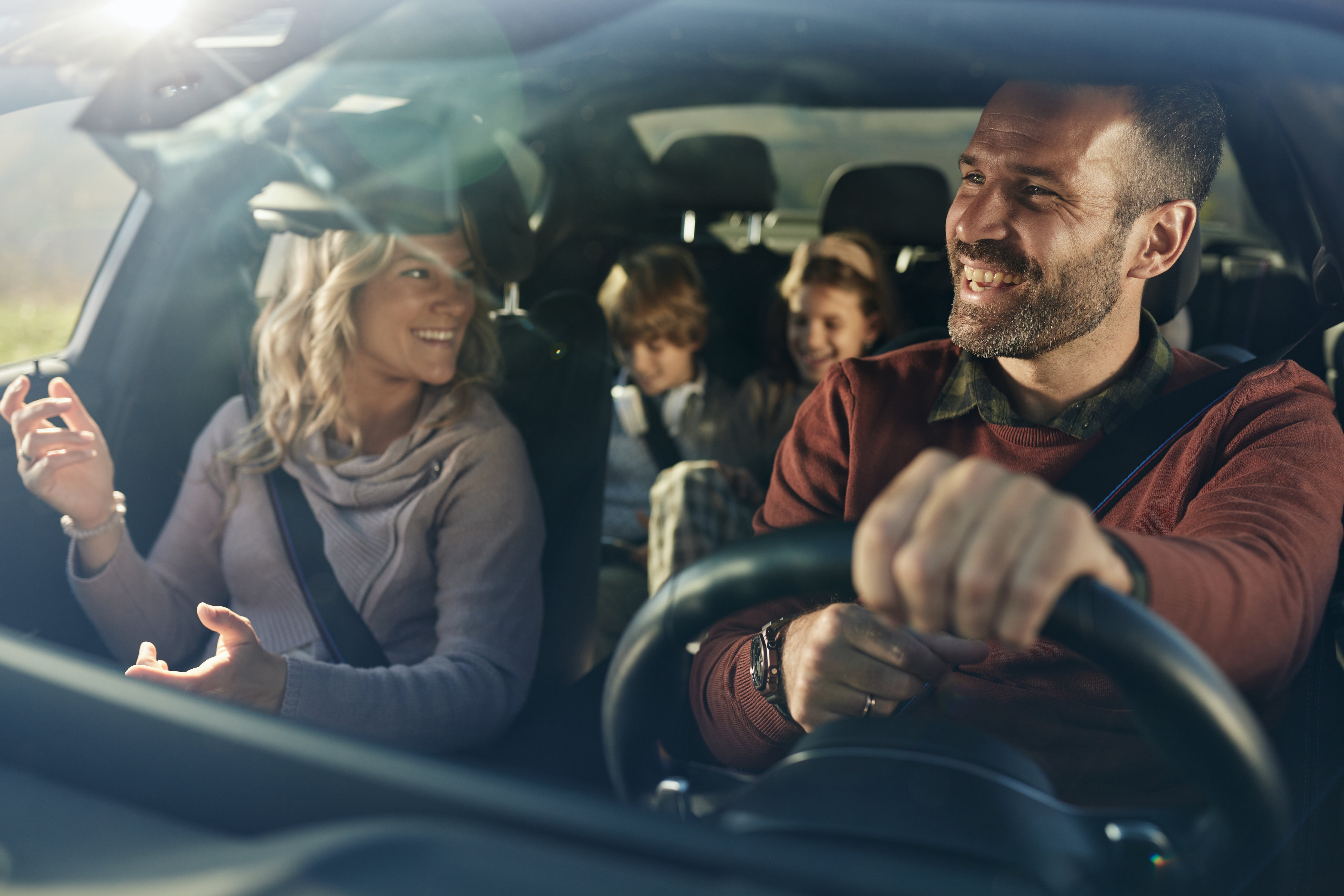 Glückliche Familie unternimmt gemeinsam einen Roadtrip mit dem Auto